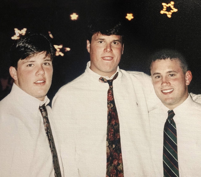 Paul, Scott, and Steven Ballard pictured together as young men, wearing white shirts and ties.